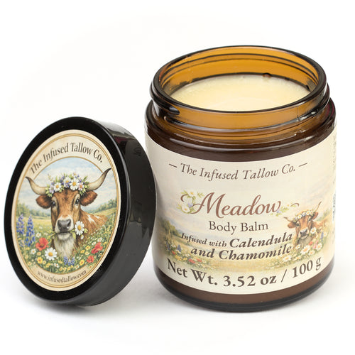 Meadow Body Balm open jar with the balm visible and lid set beside it